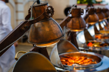 Infrared lamp to warm up food. buffet table