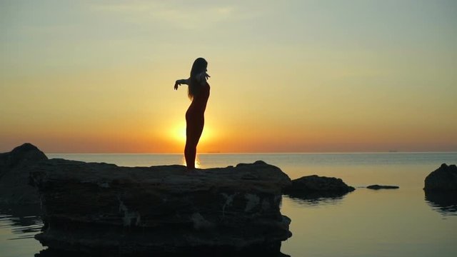 Silhouette girl do yoga namaste beautiful sundown rapid slow motion