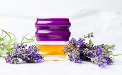 Obraz na płótnie Canvas Lavender perfume and flowers on white fabric