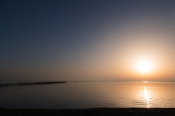 Fototapeta na wymiar Landscape of lake at sunset / Golden lake surface at sunset