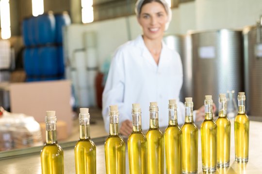 Portrait of happy worker standing at table
