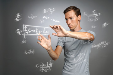 Man scientist or student working with various high school maths and science formulas.