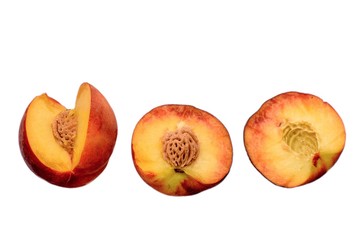 Peaches whole and sliced halves with a bone isolated on white background