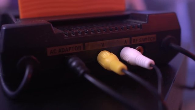 Vintage media and information technology. Entertainment 90s. Game console, gamepads