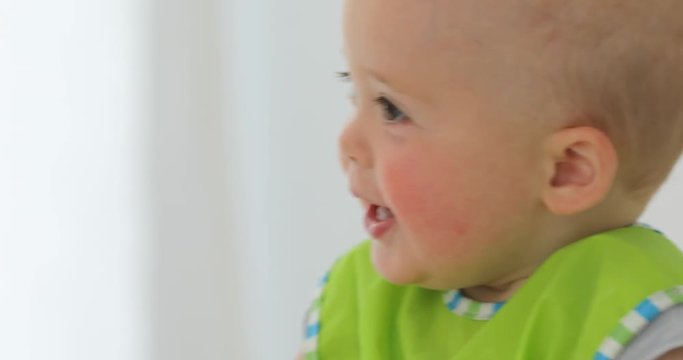 Baby is fed from a spoon, the first lure, close-up