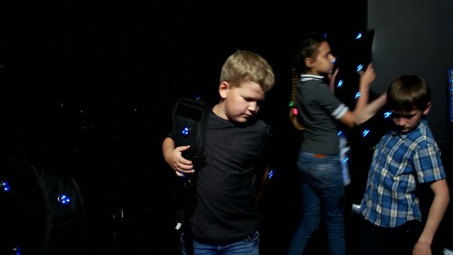 Children put on the equipment for playing laser tag