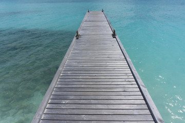Wooden pier over clear blue sea
