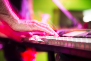 Musician plays keyboards in a rock band