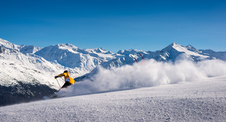 Skiier in Italian alps on fresh powder