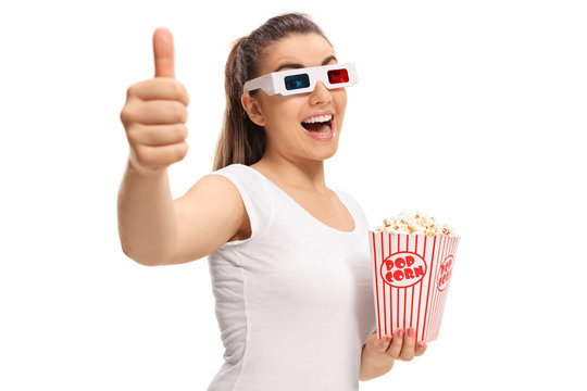 Girl with 3D glasses and popcorn making thumb up gesture