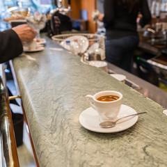 A espresso coffee on a balcony in a cafe