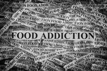 Torn pieces of paper with the words Food Addiction