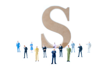 Miniature people teamwork with dollar sign background. Business concept.