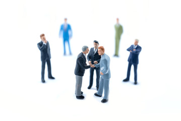 Miniature people shaking hands, Business concept.