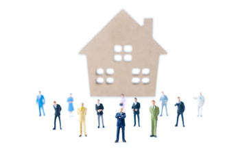Miniature people teamwork with house background. Business concept.