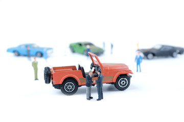 Miniature business people with car dealer in cars exhibition show