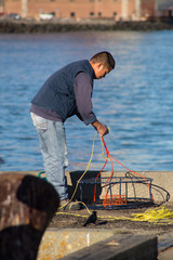 A man prepares his fishing  equipment