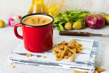 Pea soup with mashed potatoes in red enamel mug