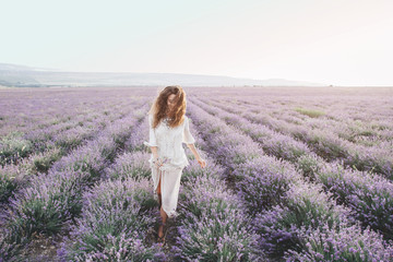 Fototapeta na wymiar Boho styled model in lavender field