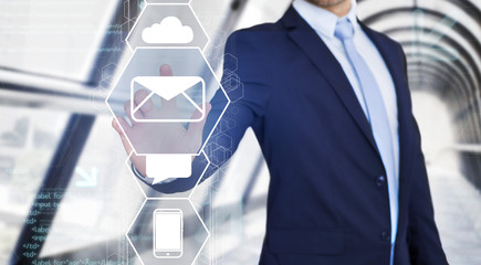 Businessman touching technology interface with business email icon