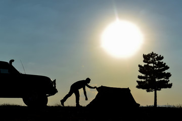 silhouette of the man and the adventurous camper