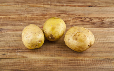 Potatoes on a wooden background