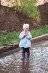 Child stay in the muddy puddle