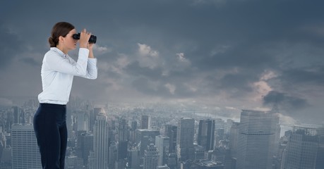 businesswoman with binoculars in cityscape