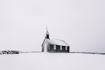Beautiful minimalistic view of Budir black church in the Snaefellsnes peninsula during severe...