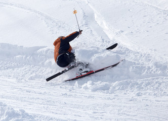 The skier fell in the snow at speed