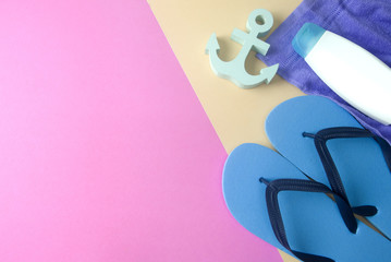 sandal and lotion with towel and anchor on colorful background