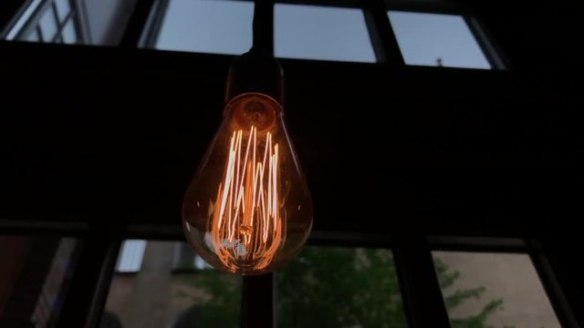 Bright halogen electric light bulbs flickering under the ceiling. Close-up shot
