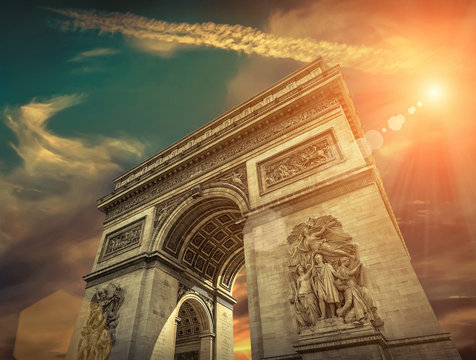 Arc de Triomphe in Paris under sky with clouds. One of symbols o