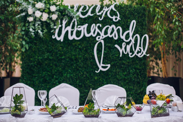 Catering in restaurant. Wedding banquet. Wedding party. Restaurant event. Banquet, wedding, catering, celebration. Wedding restaurant. Served tables. Decor in green and white colors.