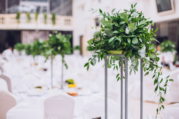 Catering in restaurant. Wedding banquet. Wedding party. Restaurant event. Banquet, wedding, catering, celebration. Wedding restaurant. Served tables. Decor in green and white colors.