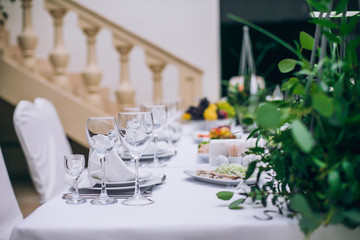 Catering in restaurant. Wedding banquet. Wedding party. Restaurant event. Banquet, wedding, catering, celebration. Wedding restaurant. Served tables. Decor in green and white colors.