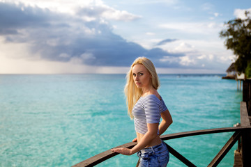 Woman in the striped T shirt on the beach