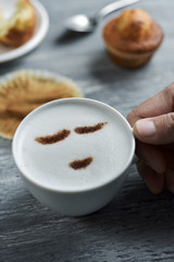 young man with a cup of cappuccino