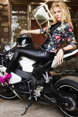 Plakat lifestyle portrait of sexy girl sitting on a motorcycle