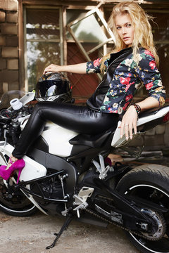 lifestyle portrait of sexy girl sitting on a motorcycle