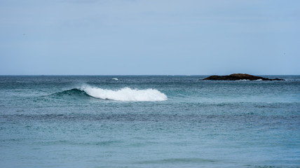 Naklejka na ściany i meble Big surfing ocean sea waves on sandy beach.