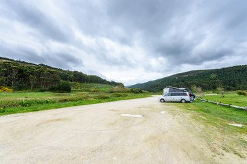 Fototapeta premium Motorhome RV and campervan are parked on a beach.