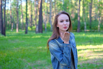 Beautiful Young Woman Blowing A Kiss, outdoor