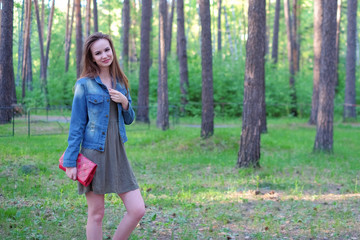 Beautiful brunette young woman poses outdoors