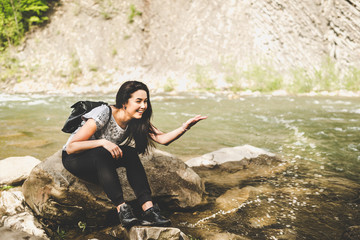 Young tourist girl enjoy nature near mountain river