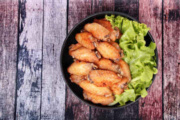 Deep fried chicken wings topped green oak.
