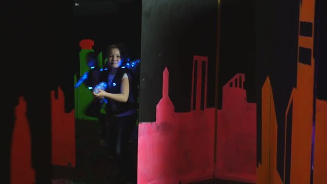 Children playing laser tag in a labyrinth