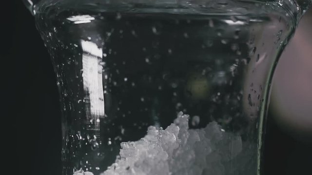 Ice is poured into a shisha flask close up