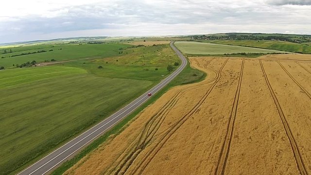 Aerial view of the sown fields near the motorway