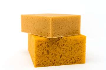 closeup cleaning sponge over white background